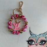 Upcycled Louis Vuitton pink charm hung from beaded wristlet bracelet. Beauty Bird Vintage