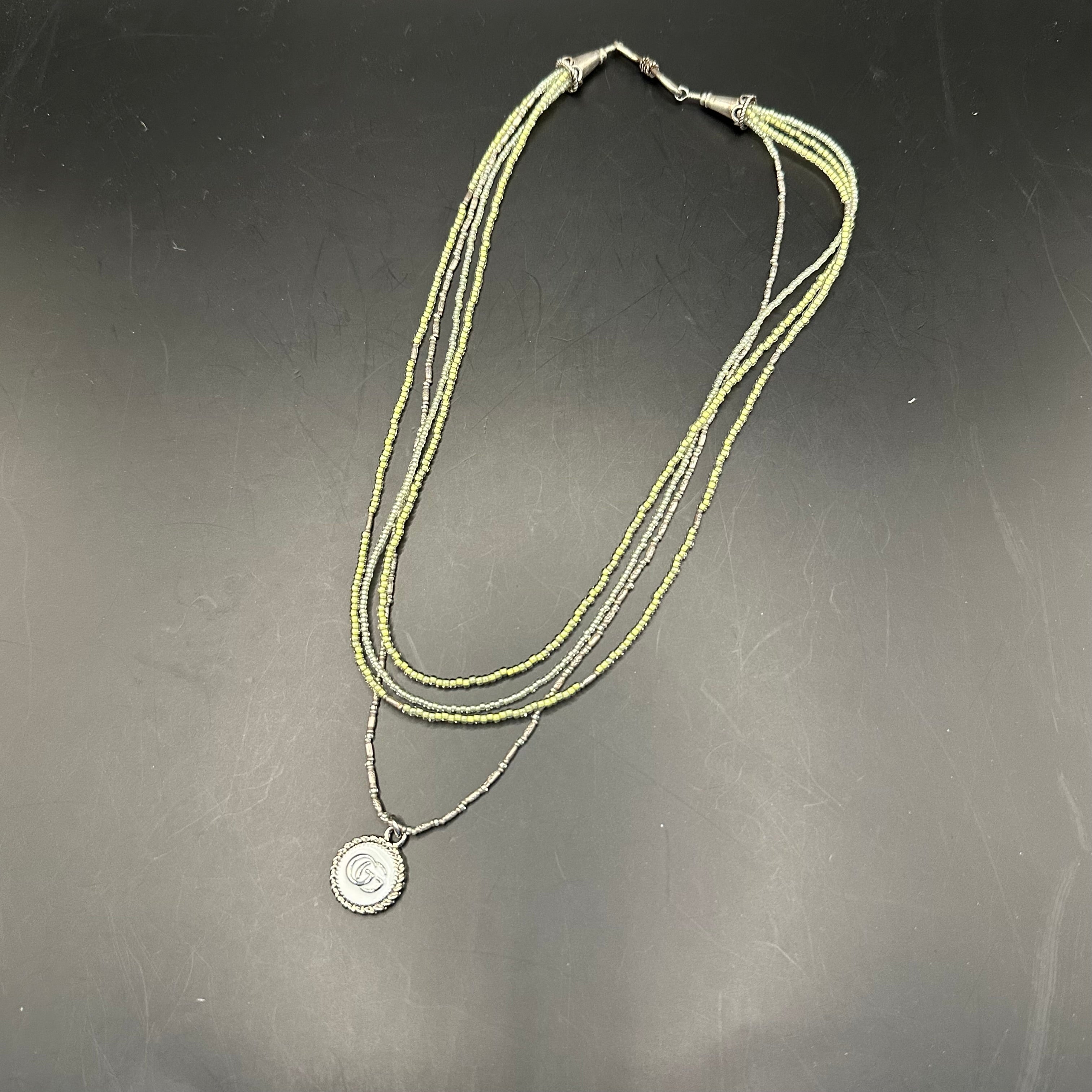 GG Pendant on Multi-Strand Pale Green Necklace