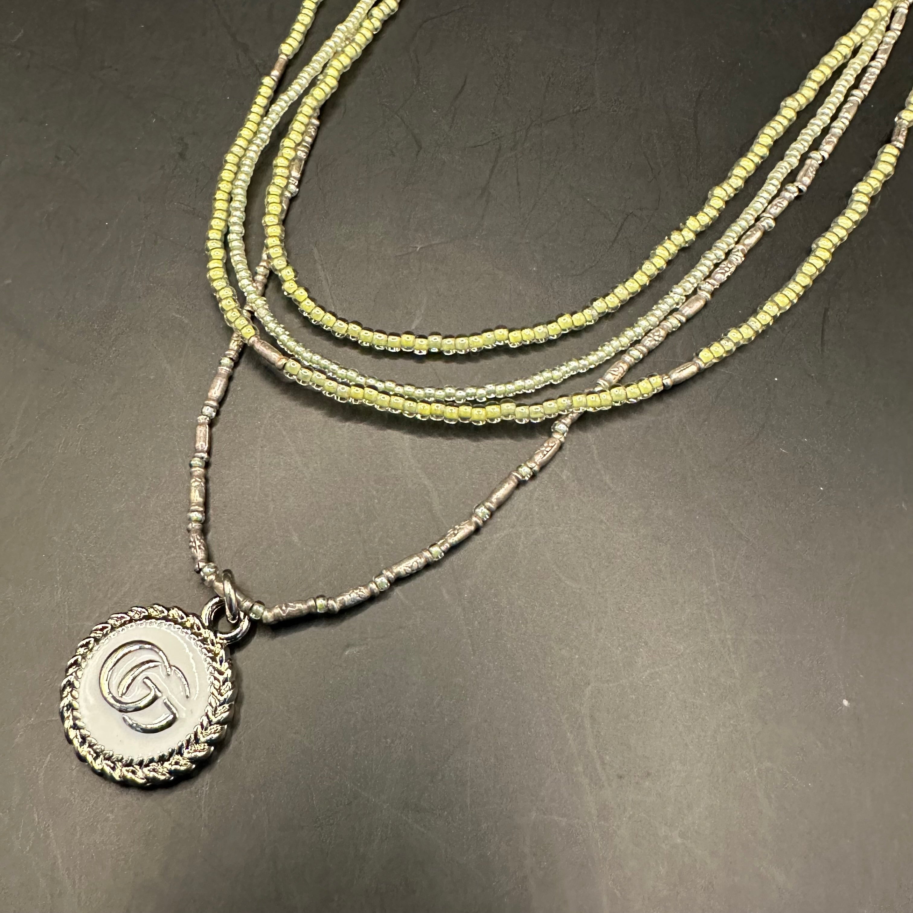 GG Pendant on Multi-Strand Pale Green Necklace