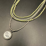 GG Pendant on Multi-Strand Pale Green Necklace