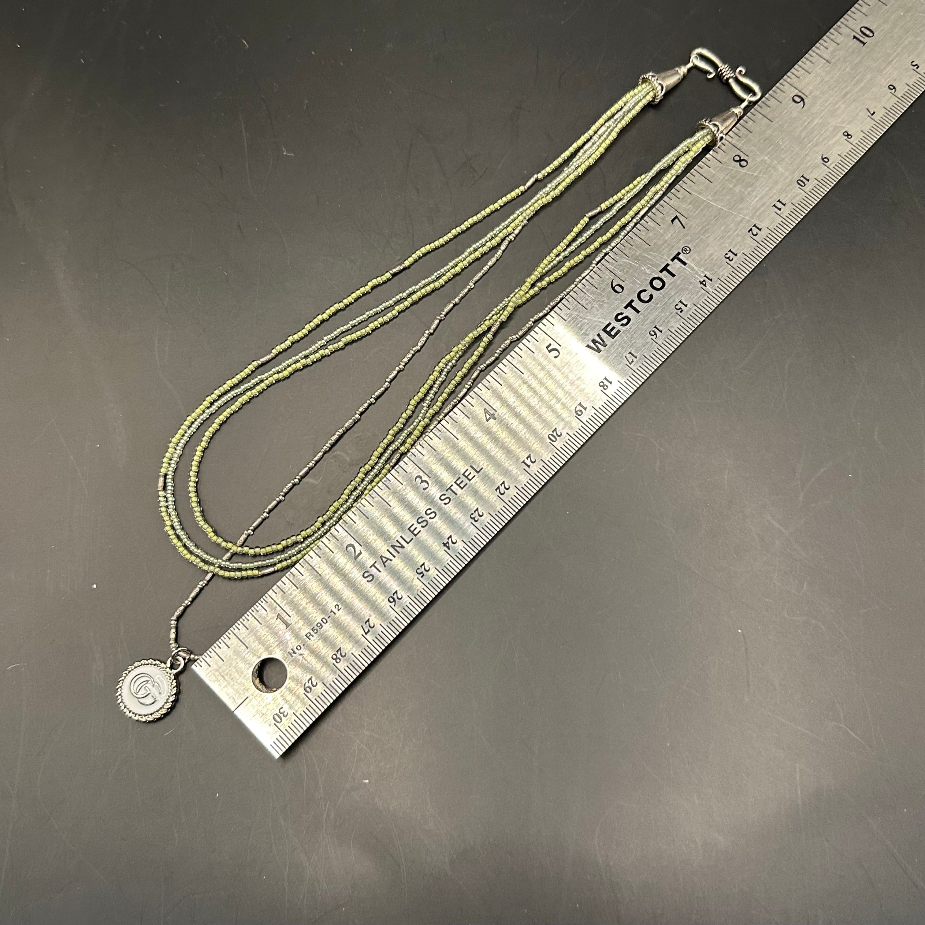 GG Pendant on Multi-Strand Pale Green Necklace